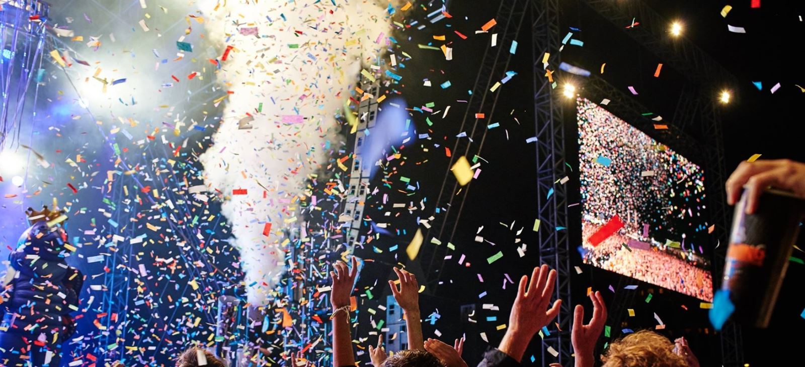 Tickertape and confetti go off above a Victorious Festival crowd